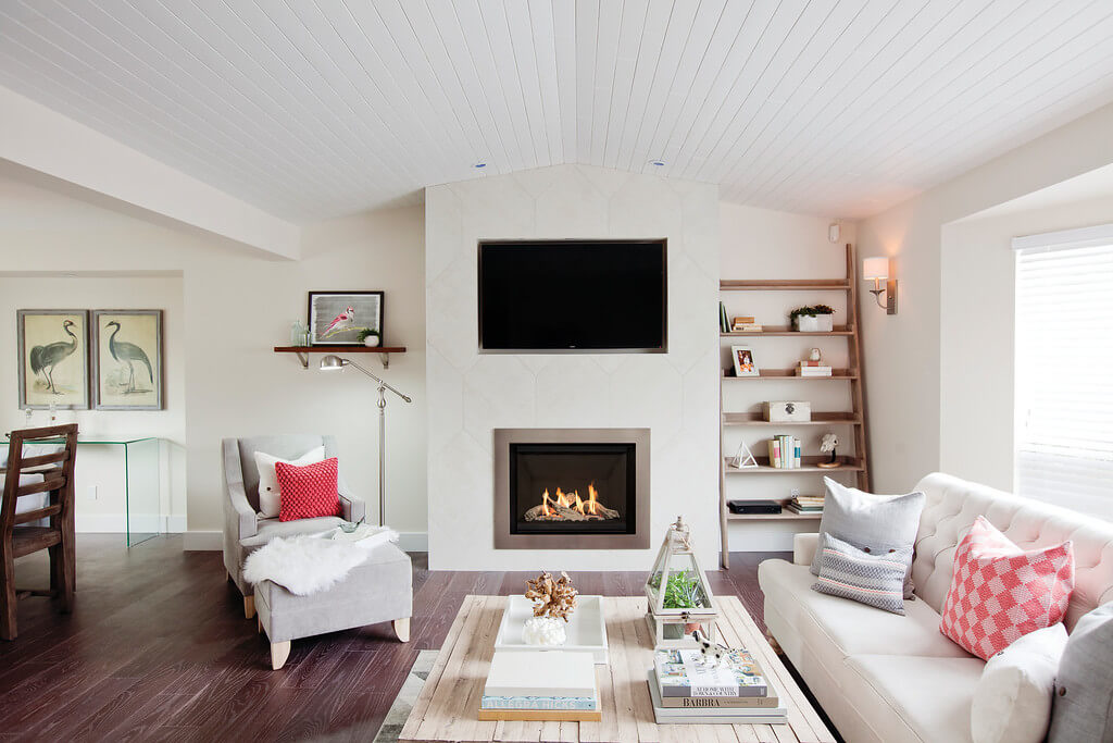 Modern farmhouse style living area has gas fireplace and TV as focal point 