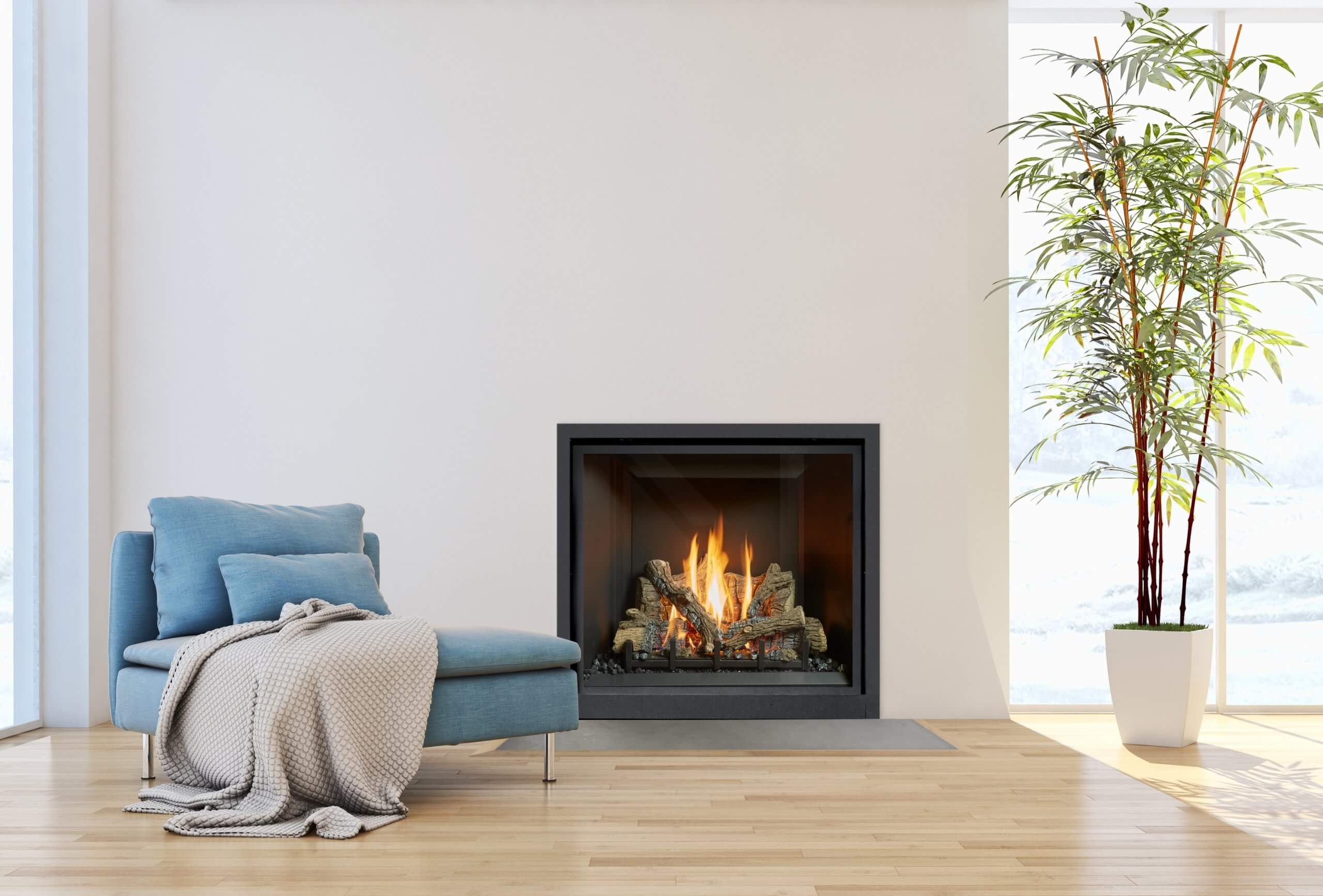 Clean face gas fireplace probuilder 36 by Fireplace Xtrordinair in a light room next to a blue arm chair