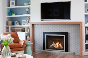 Valor G3.5 Gas Fireplace Insert with brushed nickel front and a TV mounted above
