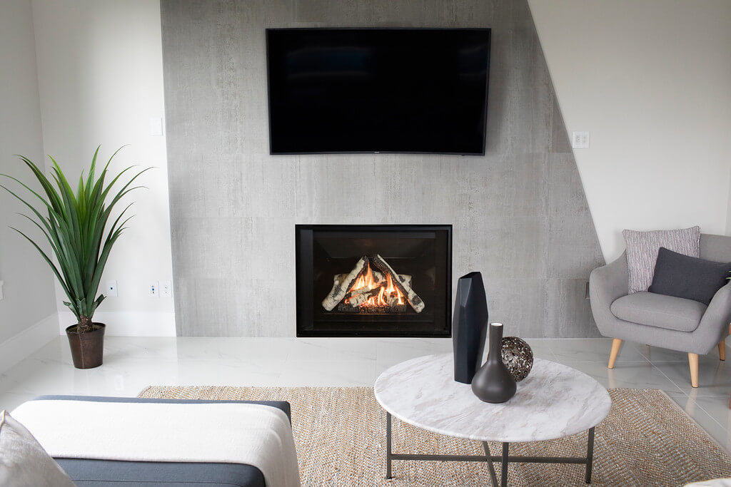 Grey finishing around a H3 Gas Fireplace by Valor